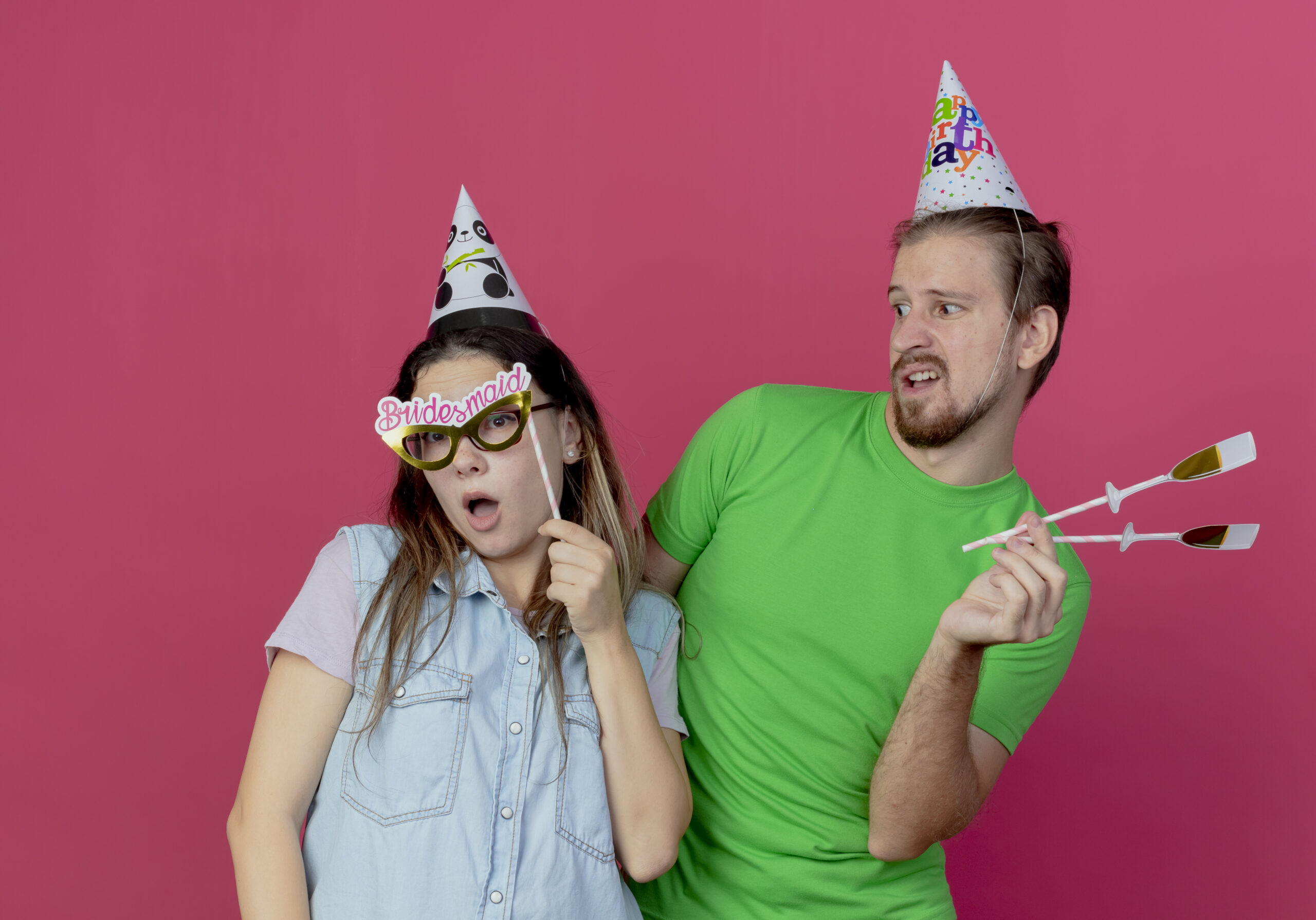 A man and a woman using a party prop to celebrate a party